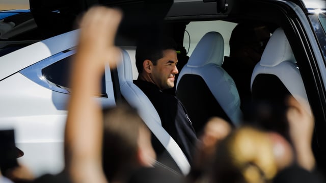 A man sits in a car. 