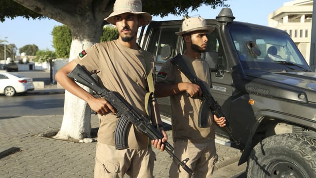 FILE - Libyan security forces stand guard in Tripoli, Libya, Tuesday, Aug. 16, 2023. One of Libya’s rival prime ministers warned Thursday, Aug. 17, 2023, that his government would not tolerate any further militia fighting, days after the year’s bloodiest bout of clashes rocked the capital, Tripoli, killing at least 45 people. (AP Photo/Yousef Murad, File)