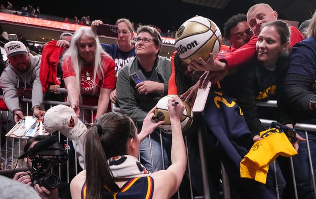 Indiana Fever guard Caitlin Clark (22) signs autographs for fans Thursday, May 9, 2024, after the preseason game against the Atlanta Dream at Gainbridge Fieldhouse in Indianapolis. The Indiana Fever defeated the Atlanta Dream, 83-80. © Grace Hollars/IndyStar / USA TODAY NETWORK