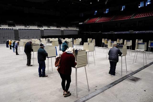 Voters complete their ballots at socially distanced privacy booths at a early voting site inside the Bismarck Event Center as the coronavirus disease (COVID-19) outbreak continues in Bismarck, North Dakota, U.S., October 26, 2020. REUTERS/Bing Guan