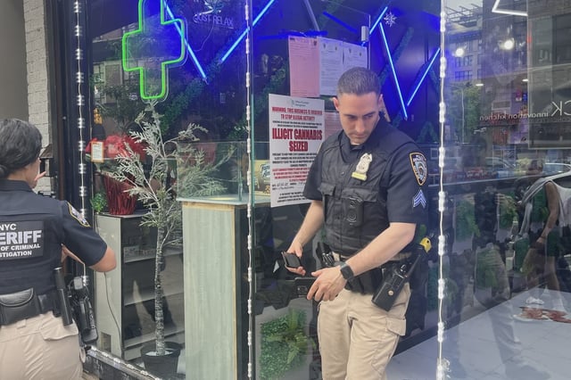 NYPD and city sheriff's officers raid a shop in SoHo as part of the city's ongoing crackdown on alleged unlicensed cannabis shops.