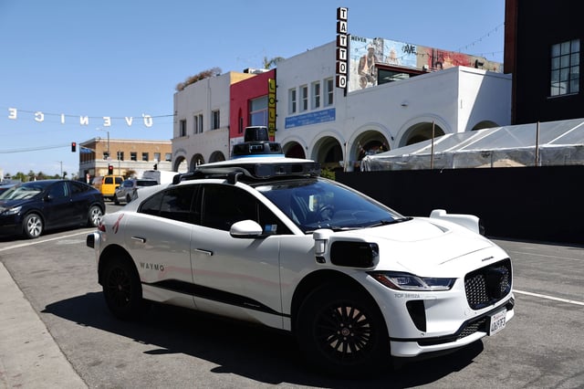 A Waymo autonomous self-driving Jaguar taxi drives near Venice Beach on March 14, 2024 in Los Angeles, California.