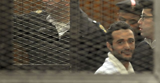 Political activist Ahmed Douma of the 6 April movement looks on behind bars in Cairo, December 22, 2013. REUTERS/Stringer 