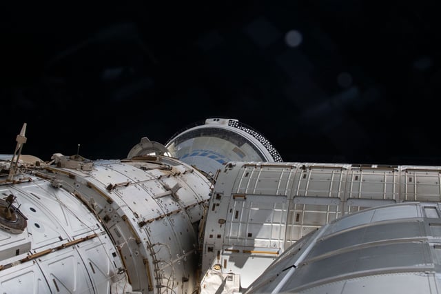 The Boeing Starliner spacecraft (far back) is seen docked with the International Space Station's Harmony module in this image shared by NASA on June 14.