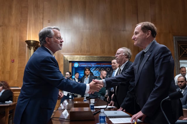 US Senator Gary Peters (left), a Michigan Democrat and chairman of the homeland security committee, greets Steven Quay, CEO of Atossa Therapeutics and former professor at Stanford University, as the panel hears from witnesses as it examines Covid-19’s origins. Photo: AP