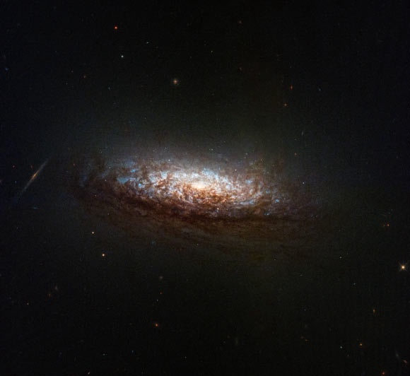 This Hubble image shows NGC 1546, a spiral galaxy approximately 52.5 million light-years away in the constellation of Dorado. Image credit: NASA / ESA / Hubblr / STScI / David Thilker, JHU.