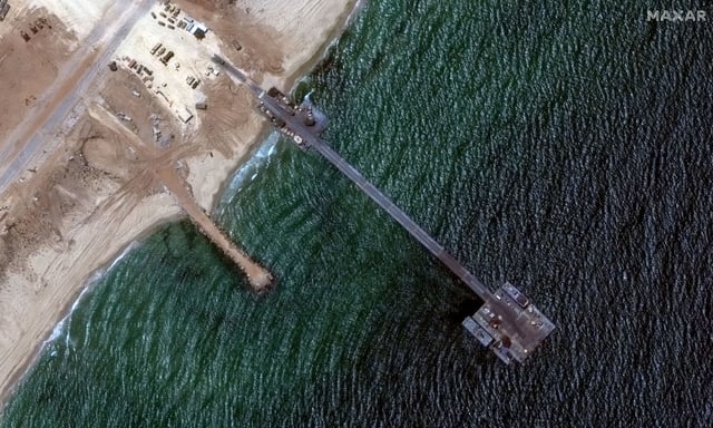 A Maxar Technologies satellite image, taken on Wednesday, June 12, shows the floating pier and ships that are using it to offload aid.