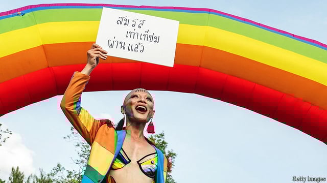 A member of the LGBTQ community celebrates after the Thai parliament passed the vote on the same sex marriage bill