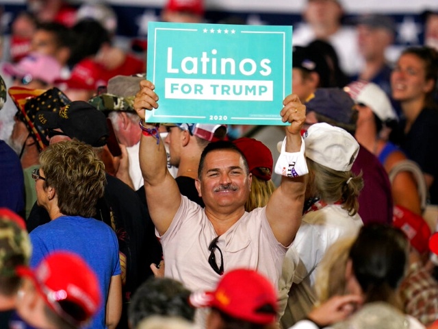 A supporter holds a sign as President Donald Trump speaks during a campaign rally at Manchester-Boston Regional Airport, Friday, Aug. 28, 2020, in Londonderry, N.H. (AP Photo/Charles Krupa)