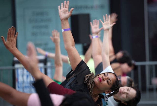 People practice yoga during the 22nd annual "Solstice in Times Square" to celebrate the summer solstice in New York City, June 20, 2024.
