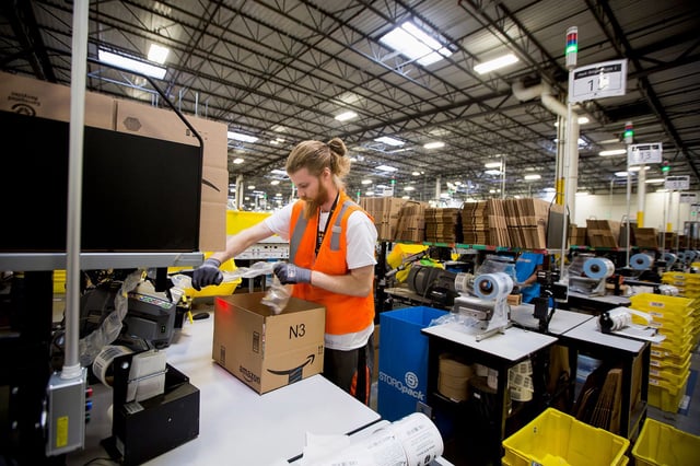 An employee packs a box at the Amazon.com Inc. fulfillment center on Cyber Monday in Robbinsville, New Jersey, U.S., on Monday, Nov. 30, 2015. Online sales on Cyber Monday may rise at least 18 percent from a year earlier, slower growth than during the holiday weekend, as consumers start their Internet shopping earlier, according to forecasts by International Business Machines Corp. Photographer: Michael Nagle/Bloomberg via Getty Images
