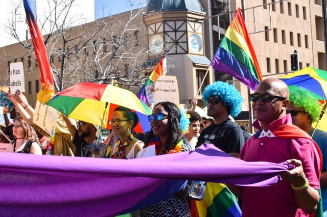 Dozens of people cheer and dance as they take part in the Namibian Lesbians, Gay, Bisexual and Transexual (LGBT) community pride Parade  on July 29, 2017.