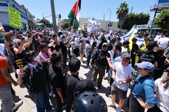 Supporters of Israel clashed with pro-Palestinian protesters in front of the Adas Torah synagogue, in Los Angeles on Sunday.