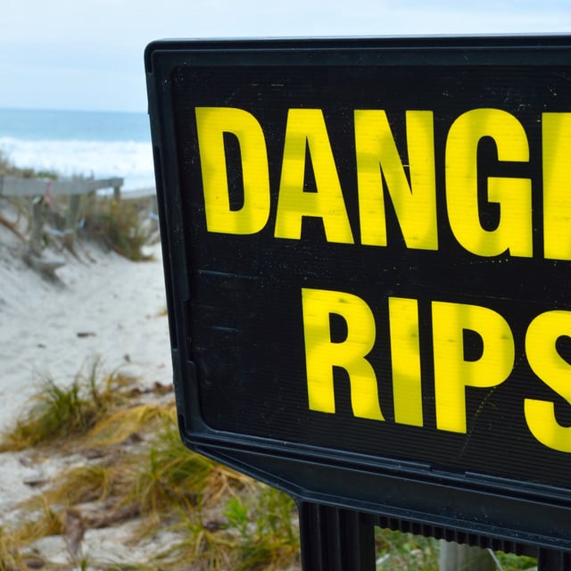 Danger rips of strong currents sign posted on the beach