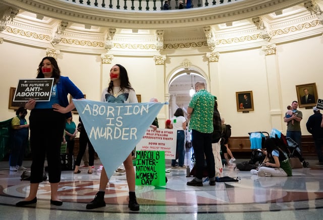 In this file photo, anti-abortion activists stand in the Texas State Capitol to protest an International Women's Day sit-in for abortion rights on March 8, 2023. Sara Diggins, Austin American-Statesman.