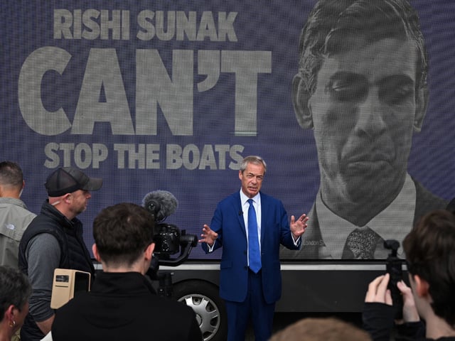 Leader of Reform UK Nigel Farage stands in front of a van reading "Rishi Sunak won't stop the boats" in reference to migrant crossings across the Channel during a campaign event in Blackpool, northwestern England, on June 20, 2024, in the build-up to the UK general election on July 4. (Photo by Oli SCARFF / AFP) (Photo by OLI SCARFF/AFP via Getty Images)