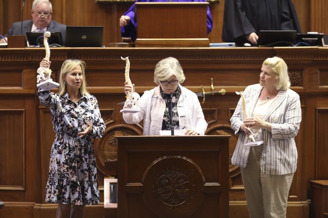 From left, Sandy Senn, Katrina Shealy, and Penry Gustafson at the South Carolina State House in Columbia, on April 19, 2023.