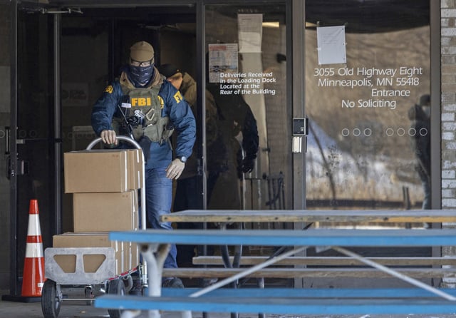 FBI agents raid the nonprofit "Feeding our Future" in St. Anthony, Minn., on Jan. 20, 2022. 