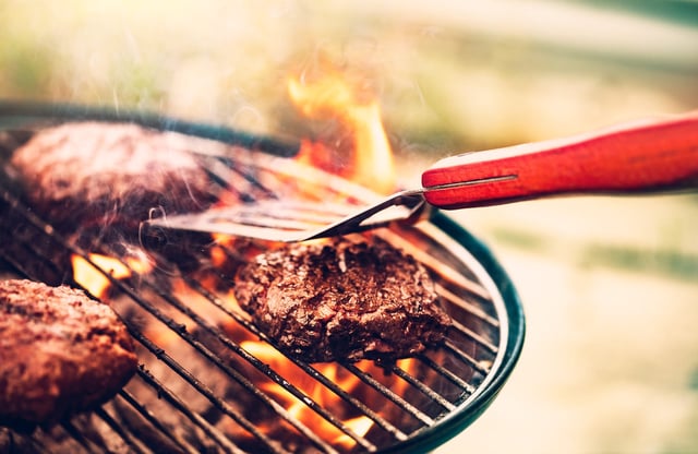 Tasty meat on the grill outdoors, preparing barbecue pork for burgers, traditional summer food cookout, good food for party outdoor.