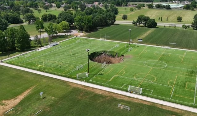 A soccer field was damaged after a giant sinkhole opened up in Alton, Ill.