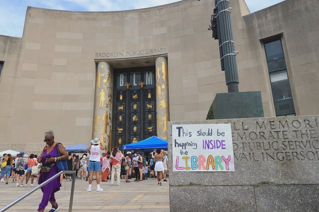 Protesters gathered outside the Brooklyn Public Library on Sunday, jointly criticizing the war in Gaza and Eric Adams' agenda.