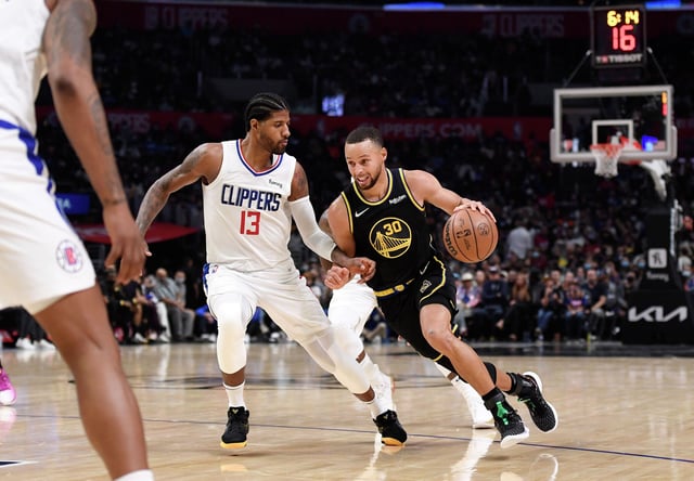 Stephen Curry of the Golden State Warriors drives against Paul George of the Los Angeles Clippers during the second half at Staples Center on Nov. 28, 2021, in Los Angeles.