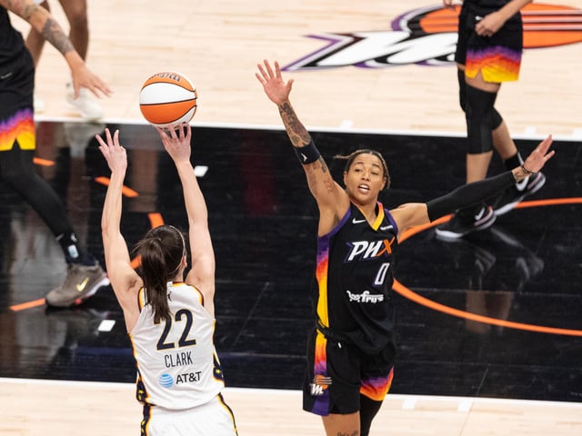 Indiana Fever guard Caitlin Clark (22) shoots over Phoenix Mercury guard Natasha Cloud (0) on June 30, 2024, at Footprint Center in Phoenix.