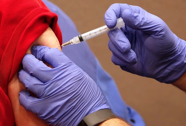Ashland Fire Department's Justin Hubler gives retired nurse Dorothy Stitzlein, who is a member of the medical reserve corp, her second dose of Moderna Covid vaccine at UH Samaritan on Main on Thursday, Feb. 25, 2021.