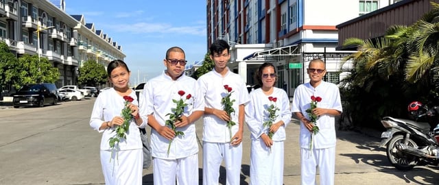 Mother Nature Cambodia Activists are dressed in white holding red flowers