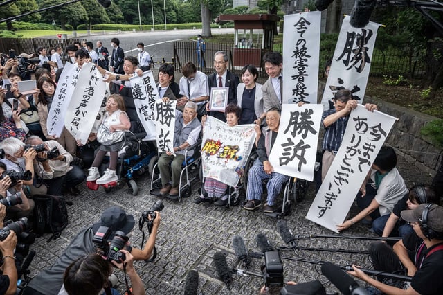 Victims of forced sterilization under a now-defunct eugenics law, celebrate with lawyers and supporters outside of the Supreme Court of Japan in Tokyo on July 3, 2024. Japan's top court ruled that a defunct eugenics law under which around 16,500 people were forcibly sterilized between 1948 and 1996 was unconstitutional, local media reported.