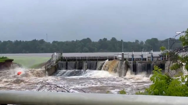Water rushes from Manawa Dam in Wisconsin on Friday.