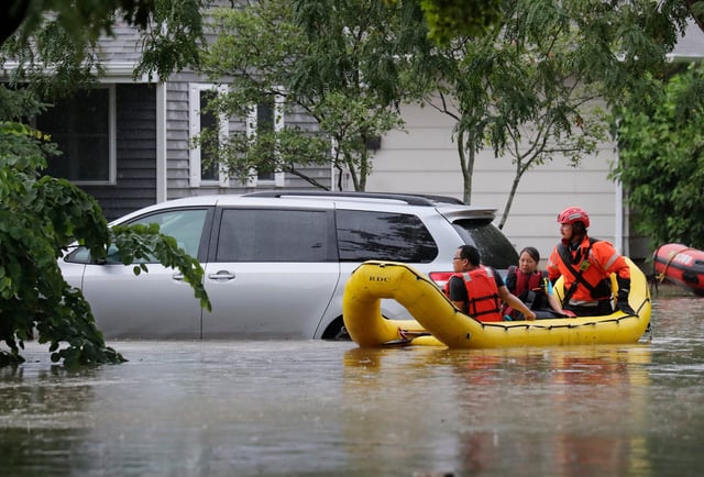 Kou and Youa Vang are evactuated from their home along N. Viola Street by the Appleton Fire Department during flash flooding Friday, July 5, 2024, in Appleton, Wisconsin.