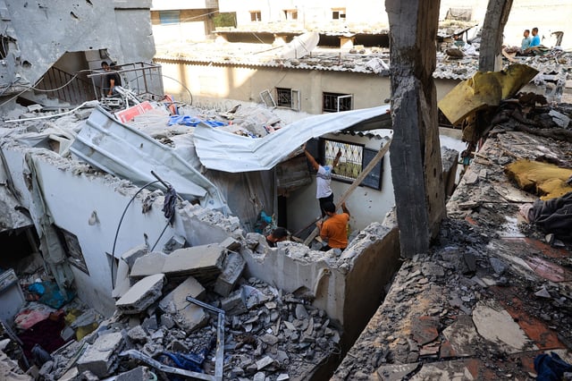Palestinians asses the damage following an Israeli strike in the Nuseirat refugee camp in the central Gaza Strip on July 6, 2024.