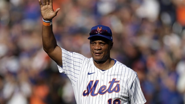 FILE - Former New York Mets' Darryl Strawberry waves as he is introduced during an Old-Timers' Day ceremony before a baseball game between the Colorado Rockies and the New York Mets on Saturday, Aug. 27, 2022, in New York. Dwight Gooden’s No. 16 and Darryl Strawberry’s No. 18 will be retired by the New York Mets in separate pregame ceremonies next year honoring players who were keys to the team’s last World Series title in 1986. (AP Photo/Adam Hunger, File)