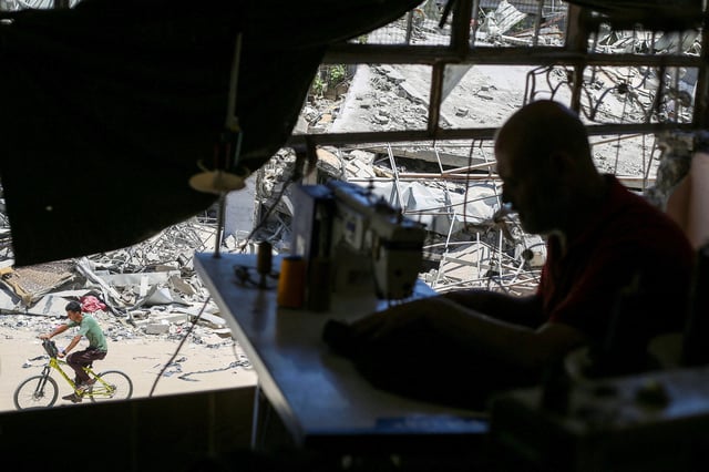 A Palestinian tailor works in a newly reopened sewing factory after the machines were retrieved from a building hit in an Israeli strike, amid Israel-Hamas conflict, in Khan Younis in the southern Gaza Strip on Wednesday.