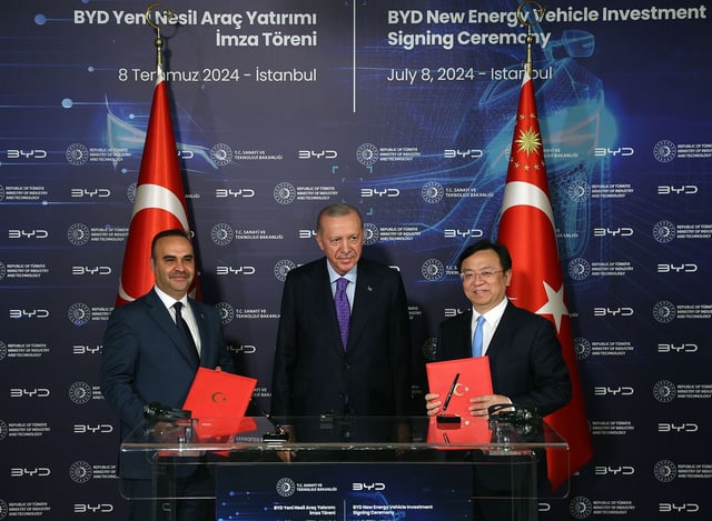 ISTANBUL, TURKIYE - JULY 08: (----EDITORIAL USE ONLY - MANDATORY CREDIT - ' TURKISH PRESIDENCY / MUSTAFA KAMACI / HANDOUT' - NO MARKETING NO ADVERTISING CAMPAIGNS - DISTRIBUTED AS A SERVICE TO CLIENTS----) Turkish President Recep Tayyip Erdogan (C), Wang Chuanfu (R), chairman and chief executive officer at BYD Co., and Turkish Minister of Industry and Technology Mehmet Fatih Kacir (L) attend the BYD New Energy Vehicle Investment Signing Ceremony after their meeting at Dolmabahce Palace working office in Istanbul, Turkiye on July 08, 2024. World's largest electric vehicle producer Chinese BYD expected to build 150,000-vehicle capacity production plant, mobility and R&D center with investment worth $1B in Turkiye, according to ministry. (Photo by Turkish Presidency/ Mustafa Kamaci / Handout/Anadolu via Getty Images)