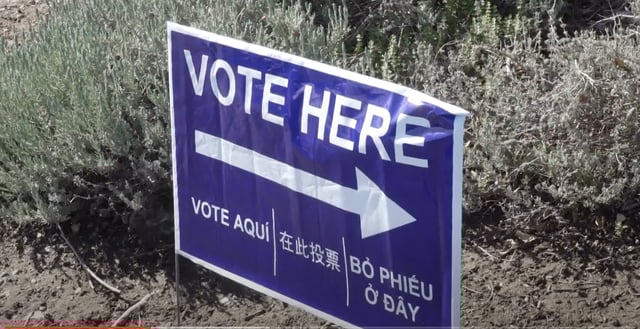 Sign instructing voters where to vote.