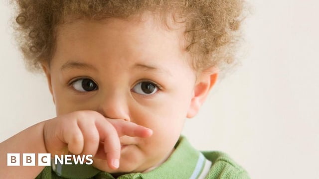 picture of young child wiping his nose