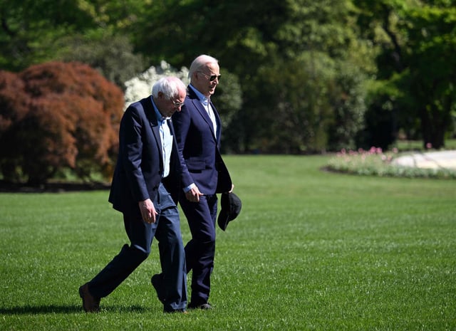 US President Joe Biden (right) walks with US Senator Bernie Sanders across the South Lawn of the White House in April. Photo: AFP