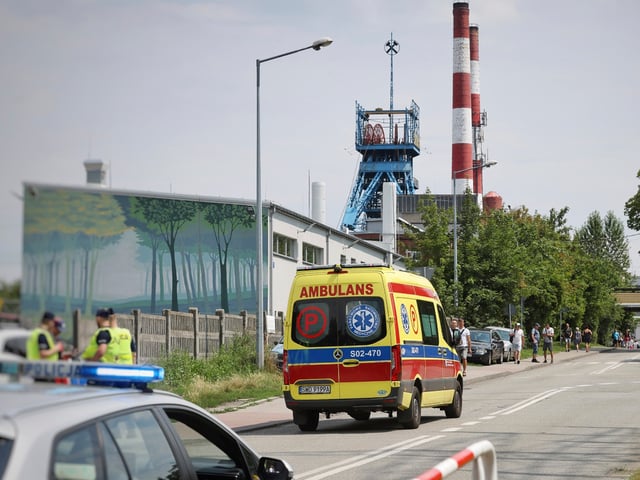 An ambulance heads into the Rydultowy coal mine near the city of Rybnik, in southern Poland, on Thursday, July 11, 2024. Officials say that two Polish coal miners remain unaccounted for and at least 15 have been injured after a powerful tremor shook the Rydultowy coal mine. Rescuers are struggling to reach dozens of others. (AP Photo/Katarzyna Zaremba-Majcher)