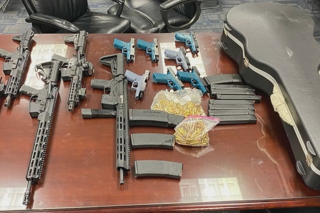 Some of the guns and ammunition and the guitar case that were seized as part of a law enforcement investigation into an alleged gun trafficking ring in Queens