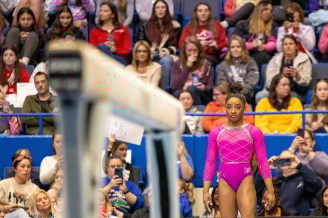 Biles prepares for a balance-beam routine at the Core Hydration Classic in Hartford, Conn., on May 18