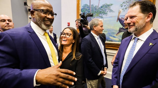 St. Petersburg Mayor Ken Welch, left, is congratulated by Rays chief public affairs & communications officer Rafaela Amador Fink and Rays president Brian Auld after the city council voted to approve the 12 agreements with the Rays and Hines that form the foundation of the plan for a ballpark and the Historic Gas Plant District on Thursday.