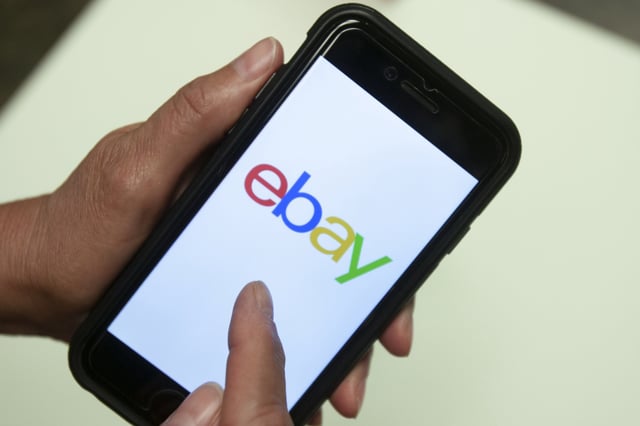 An eBay app is shown on a mobile phone, July 11, 2019, in Miami. (AP Photo/Wilfredo Lee, File)