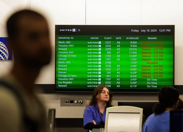 Flight delays are visible on the departure sign at the United ticketing counter as some flights remained affected due to Microsoft's global outage at Tampa International Airport on Friday.