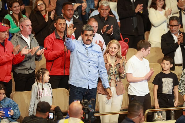Venezuelan President Nicolas Maduro with his wife and primera combatiente Cilia Flores greets the audience during the presentation of a biographical film and a book about Maduro at the Teresa Carreño Theater on July 14, 2024 in Caracas, Venezuela.