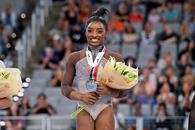 Jun 2, 2024; Fort Worth, Texas, USA; Simone Biles of World Champions Centre poses for a photo with her gold medal and commemorative belt buckle after finishing in first in the women’s 2024 Xfinity U.S. Gymnastics Championships at Dickies Arena.