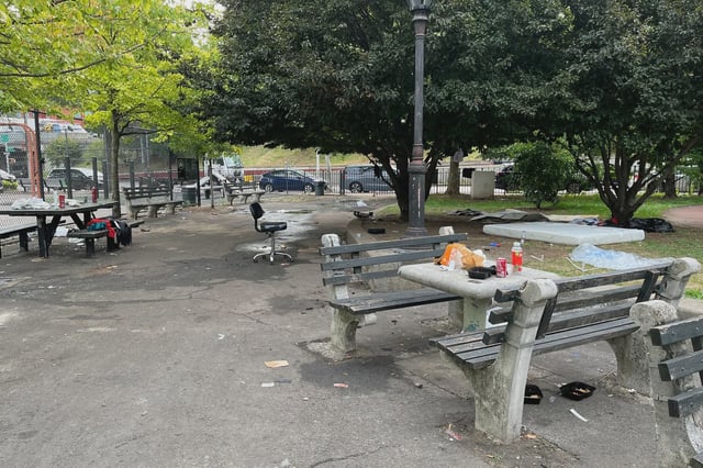 Migrants say they sleep in the park at Flushing Avenue and Steuben Street because they've been time-limited in the city's shelter system