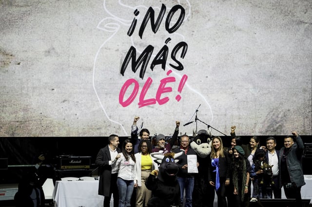 Colombian President Gustavo Petro holds up a law that bans bullfighting, in La Plaza Santa Maria, Bogota, Colombia, Monday, July 22, 2024. (AP Photo/Ivan Valencia)