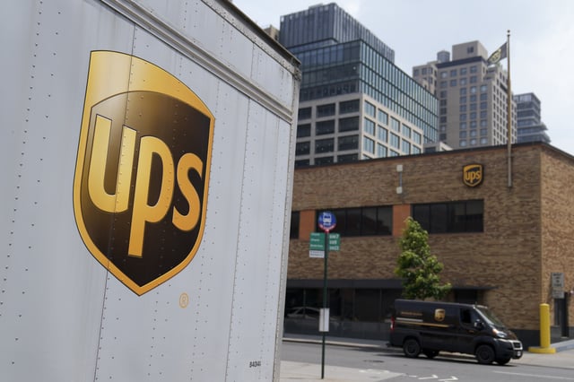 A delivery vehicle passes by a UPS depot, June 29, 2023, in New York. (AP Photo/John Minchillo, File)